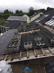 We start by removing the roof tiles to assess the damage