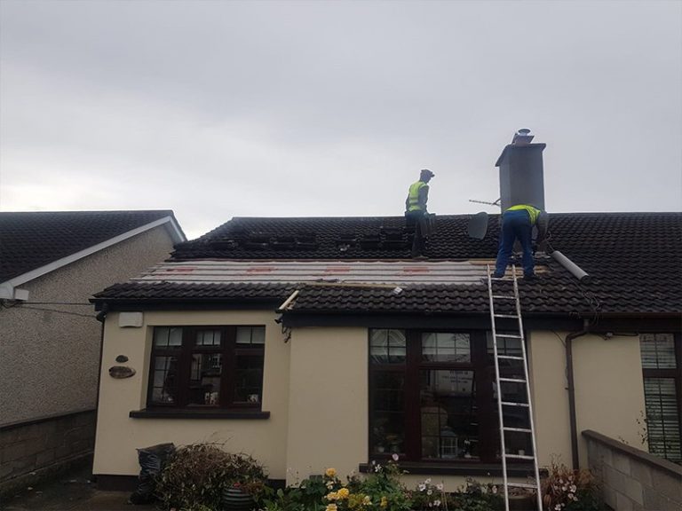 Roof being repaired after damage